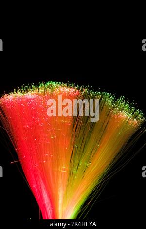 Lit bundle of red green and yellow fibre optic strands. Stock Photo