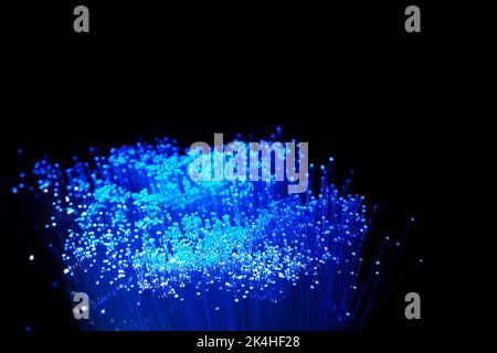Bundle of blue lighted fibre optic strands. Stock Photo