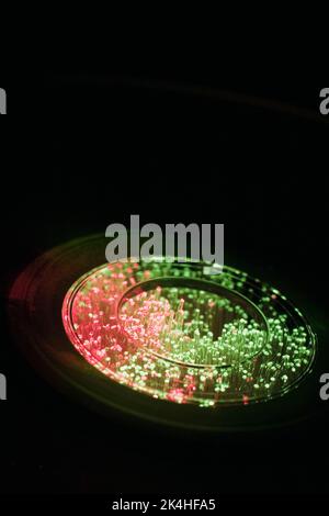 Fibre optic strands through DVD disc. Stock Photo