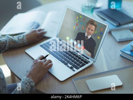 Mid section of female teacher having a video call with male student on ...