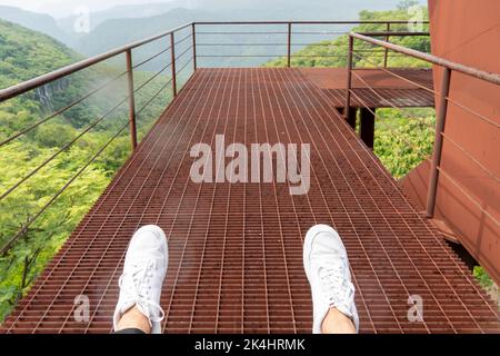 rusty old cable car, cable car ride in the rain, views of the canyon, vegetation and people. Mexico Stock Photo