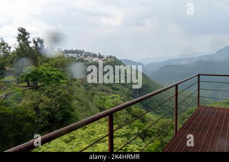 rusty old cable car, cable car ride in the rain, views of the canyon, vegetation and people. Mexico Stock Photo