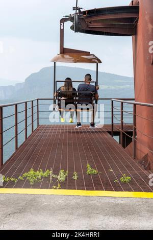 rusty old cable car, cable car ride in the rain, views of the canyon, vegetation and people. Mexico Stock Photo