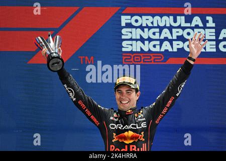 Singapore. 2nd Oct, 2022. Red Bull's Mexican driver Sergio Perez celebrates during the trophy ceremony after winning the Formula One Singapore Grand Prix Night Race at the Marina Bay Street Circuit in Singapore, on Oct. 2, 2022. Credit: Then Chih Wey/Xinhua/Alamy Live News Stock Photo