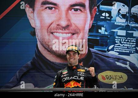 Singapore. 2nd Oct, 2022. Red Bull's Mexican driver Sergio Perez celebrates during the trophy ceremony after winning the Formula One Singapore Grand Prix Night Race at the Marina Bay Street Circuit in Singapore, on Oct. 2, 2022. Credit: Then Chih Wey/Xinhua/Alamy Live News Stock Photo