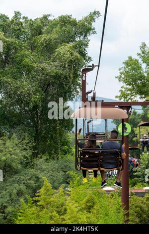 rusty old cable car, cable car ride in the rain, views of the canyon, vegetation and people. Mexico Stock Photo