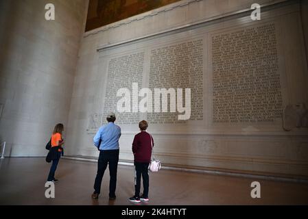 Visitors read Abraham Lincoln's 2nd Inaugural Address memorialized on the wall at the Lincoln Memorial in Washington, DC. Stock Photo