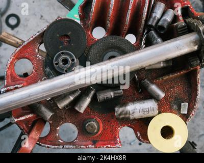 Set of tools over a metal panel and pipes, old Stock Photo