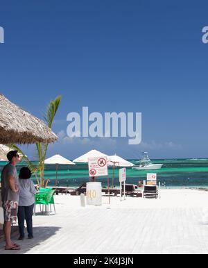 Higüey, La Altagracia, August 31, 2013: Tourist couple looking out onto the beach Stock Photo