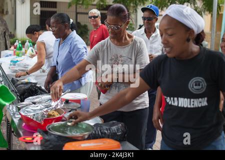 Boca Chica, Santo Domingo, November 25, 2012: Volunteers feeding the hungry in Boca Chica. Stock Photo