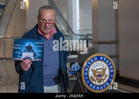 NEW YORK, NY – OCTOBER 02: Senate Majority Leader, U.S. Senator Chuck Schumer (D-NY) holds up a sign with a symbolic hacker on it on October 2, 2022 in New York City. New York Senator Chuck Schumer is calling on the federal government to release more information about recent data breaches, and to increase their efforts to protect consumers from cyber security breaches and investigate those responsible for such hacks. Credit: Ron Adar/Ģ����ý Live News Stock Photo