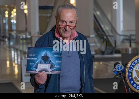NEW YORK, NY – OCTOBER 02: Senate Majority Leader, U.S. Senator Chuck Schumer (D-NY) holds up a sign with a symbolic hacker on it on October 2, 2022 in New York City. New York Senator Chuck Schumer is calling on the federal government to release more information about recent data breaches, and to increase their efforts to protect consumers from cyber security breaches and investigate those responsible for such hacks. Credit: Ron Adar/Ģ����ý Live News Stock Photo