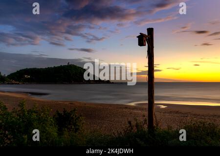 Sunrise on the beach with lighthouses on the mountain in Thach Hai commune, Thach Ha, Ha Tinh, VN Stock Photo