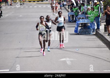 Kenian runners Angela Tanui abd Veribucah Nyaruai take first and second place as Nazret Weldu from Eritrea runs on third during the comeback after two years of Bogota's Half Marathon due to the COVID-19 Pandemic, in Bogota, Colombia, October 2, 2022. Kenian's Edwin Soi T: 1:05:27 and Angela Tanui T: 1:13:29 won the respective male and female 21k race. Photo by: Cristian Bayona/Long Visual Press Stock Photo