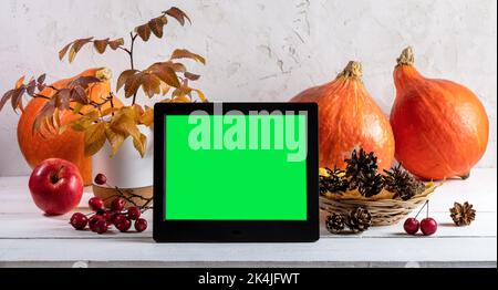 Fall, autumn harvest, Halloween or Thanksgiving day concept. Pumpkins, color leaves, red apples, pine cones on light neutral background. Electronic ph Stock Photo