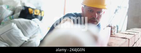 Concentrated male builder measure distance with level equipment Stock Photo