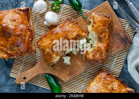Mini chicken and mushroom puff pastry pies Stock Photo
