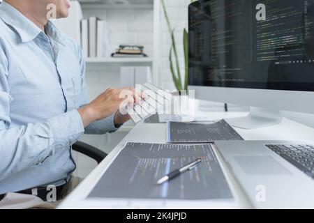 Software development concept, Male programmer using keyboard to typing data codes on computer. Stock Photo