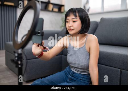 Concentrated vlogger preparing for a beauty vlog Stock Photo