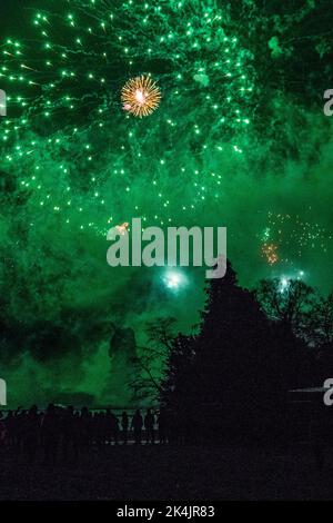 A silhouette of people on the fireworks show in Alton Towers theme park Stock Photo