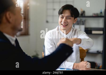 Business people showing Fist Bump after meeting partnership. Teamwork Concept. Stock Photo