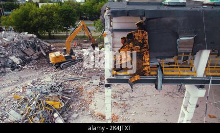06.08.2022 - Warsaw, Poland - The excavator working on the dismantling and demolition site. High quality photo Stock Photo