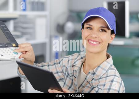 happy young woman on printer maintenance Stock Photo