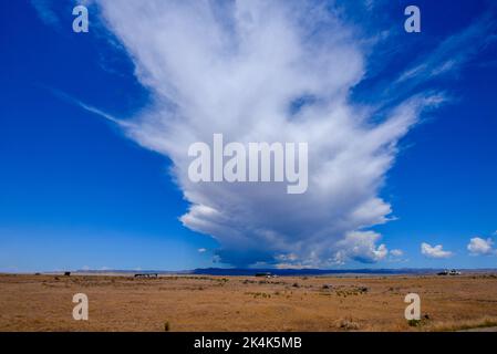 A huge storm cloud over the hills of Colorado seen from the desert near the Utah border in the USA Stock Photo