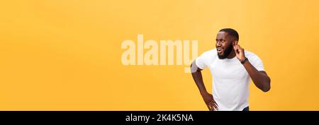 Headshot of goofy surprised bug-eyed young dark-skinned man student wearing casual white t-shirt staring at camera with shocked look. Stock Photo