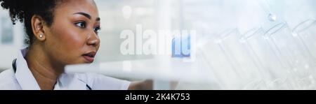 science technology chemist developing concept, female researcher, medical scientist or doctor or student with test tube of clear liquid in laboratory Stock Photo