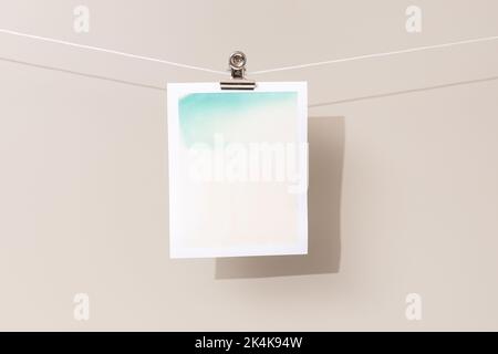 instant photo frame with green and beige patches hanging on a rope Stock Photo