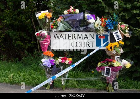 Cippenham, Slough, Berkshire, UK. 3rd October, 2022. Floral tributes at the scene. Thames Valley Police have launched a murder investigation following an incident in Slough. At about 8.50pm yesterday evening 2nd October, 2022 officers received a report that a male had been seriously injured in Waterman Court, Cippenham. Officers attended the scene where it was established that a 21-year-old man had been in a collision on his bicycle with a car, believed to be a black Volkswagen Golf in Earls Lane. Credit: Maureen McLean/Alamy Live News Stock Photo