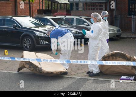 Cippenham, Slough, Berkshire, UK. 3rd October, 2022. Crime Forensic Investigators at the scene. Thames Valley Police have launched a murder investigation following an incident in Slough. At about 8.50pm yesterday evening 2nd October, 2022 officers received a report that a male had been seriously injured in Waterman Court, Cippenham. Officers attended the scene where it was established that a 21-year-old man had been in a collision on his bicycle with a car, believed to be a black Volkswagen Golf in Earls Lane. Credit: Maureen McLean/Alamy Live News Stock Photo