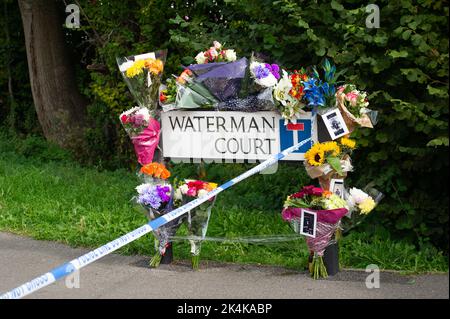 Cippenham, Slough, Berkshire, UK. 3rd October, 2022. Floral tributes at the scene. Thames Valley Police have launched a murder investigation following an incident in Slough. At about 8.50pm yesterday evening 2nd October, 2022 officers received a report that a male had been seriously injured in Waterman Court, Cippenham. Officers attended the scene where it was established that a 21-year-old man had been in a collision on his bicycle with a car, believed to be a black Volkswagen Golf in Earls Lane. Credit: Maureen McLean/Alamy Live News Stock Photo
