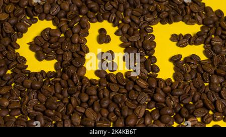 The word coffee is written on coffee beans. Stock Photo