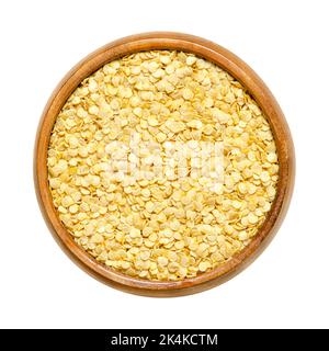 Bell pepper seeds, in a wooden bowl. Dried slightly yellow seeds of Capsicum annuum, also known as paprika, sweet pepper or capsicum. Stock Photo