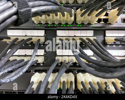 Ethernet cables connected to the network equipment Stock Photo