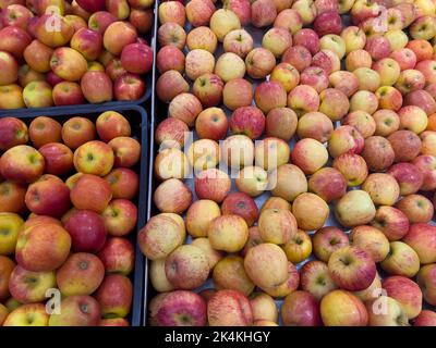 Fresh ripe red apples for sale on display at the fruits section in a supermarket. Stock Photo