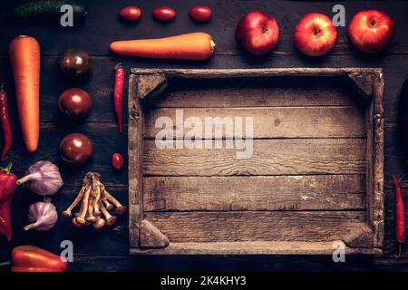 wooden box concept of healthy eating or delivery of food and fresh vegetables and fruits. Empty wooden box on a black rustic background copy space, ha Stock Photo
