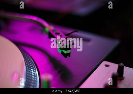 Turntables needle cartridge on vinyl player tone arm. Professional dj turntable on concert stage. Play records with music on turn table device Stock Photo