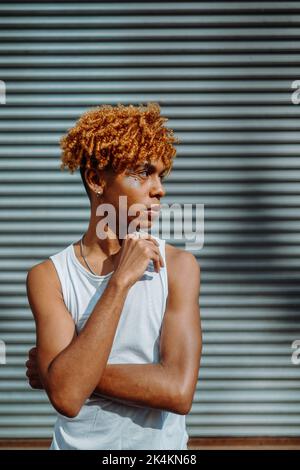 Side view of the confident teenager with creative makeup posing outdoors Stock Photo