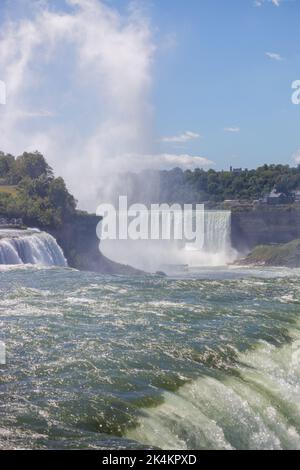 A raging waterfalls surrounded by trees Stock Photo - Alamy