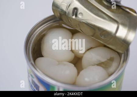 longans fruits in a tin container table  Stock Photo