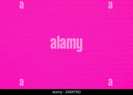 The background is made of purple material. Fabric for sewing clothes in a dark shade. Texture Stock Photo