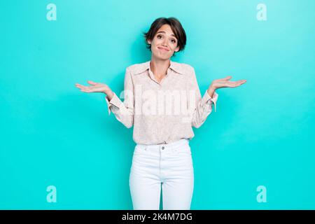 Photo of pretty cute lady wear stylish trendy outfit raise arm palm grimace cant help you excuse me isolated on cyan color background Stock Photo