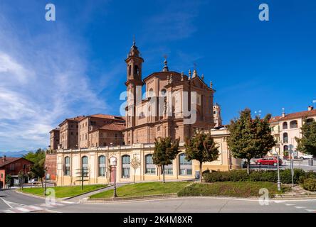 Fossano, Cuneo, Piedmont, Italy - October 03, 2022: The church of the Holy Trinity or Battuti Rossi (beaten reds) with the hospital building of the ho Stock Photo