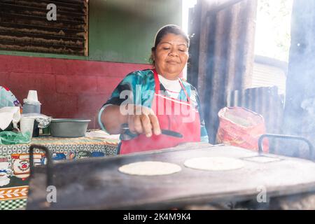 Woman Flipping A Corn Tortilla With A Spatula In A Hot Griddle Stock Photo  - Download Image Now - iStock