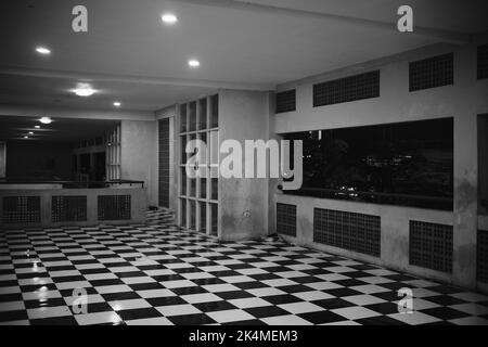 Monochrome photo of a room with a chessboard patterned floor in the Cicalengka area - Indonesia Stock Photo