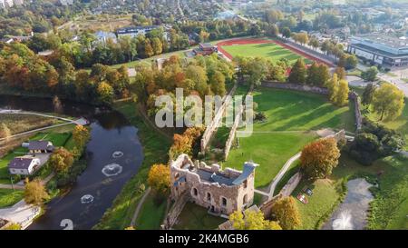 Ruins of an Ancient Medieval Castle Dobele Latvia, Aerial Top View. Aerial Panorama of Dobele City, in the Foreground River With Fontains and Medieval Stock Photo