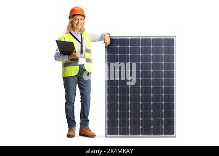 Full length portrait of a female engineer leaning on a photovoltaic panel isolated on white background Stock Photo